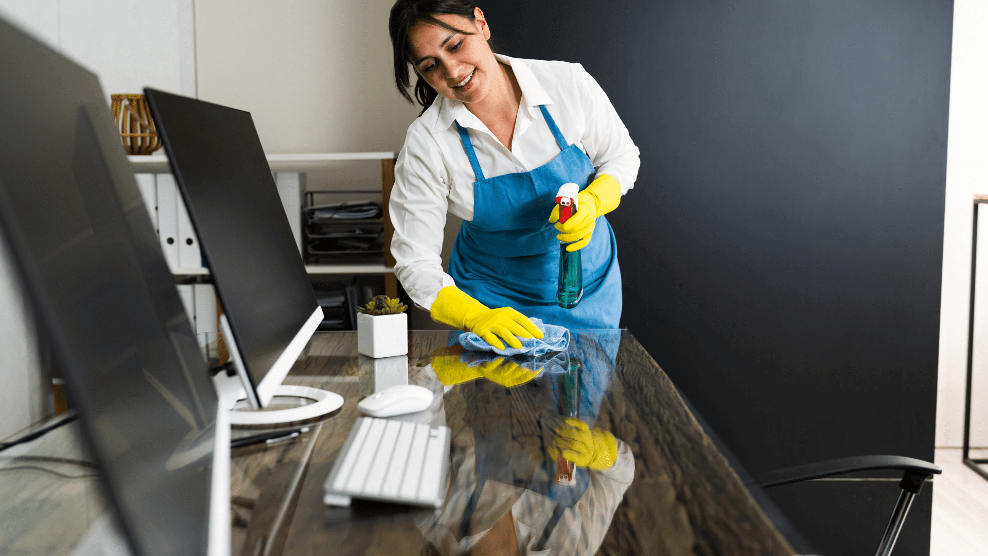 a woman wiping down a desk